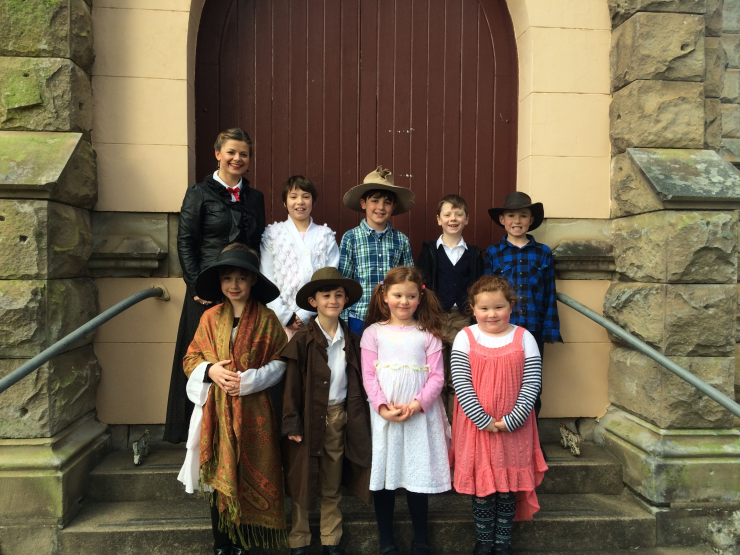 Alice and students outside the church