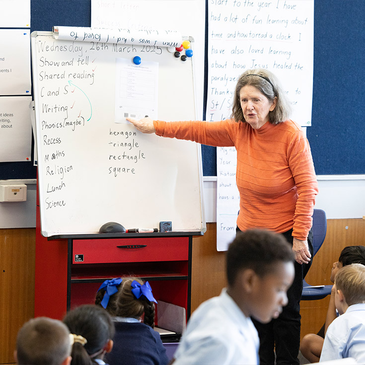 St Canice's Katoomba student reading to class off of a whiteboard