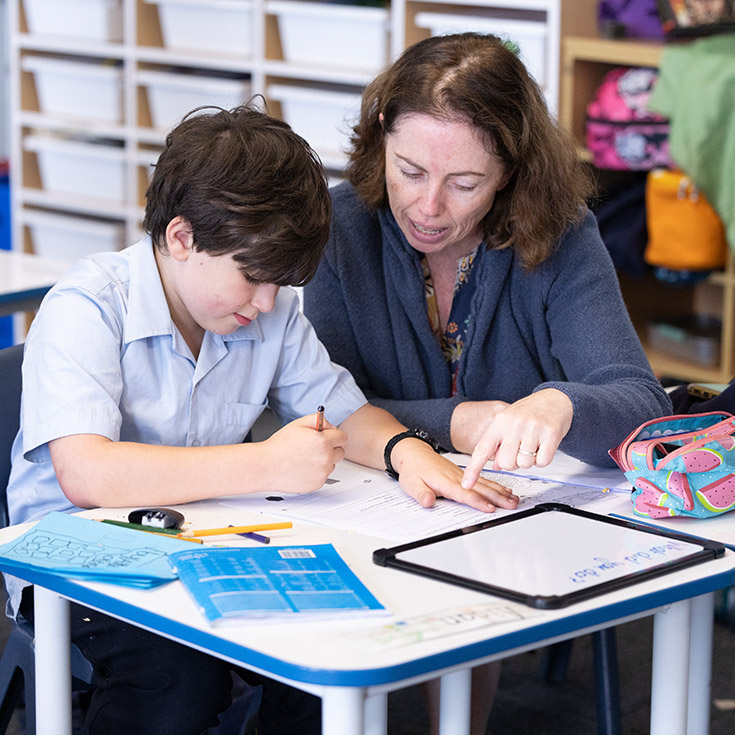 St Canice's Katoomba teacher assisting student with maths