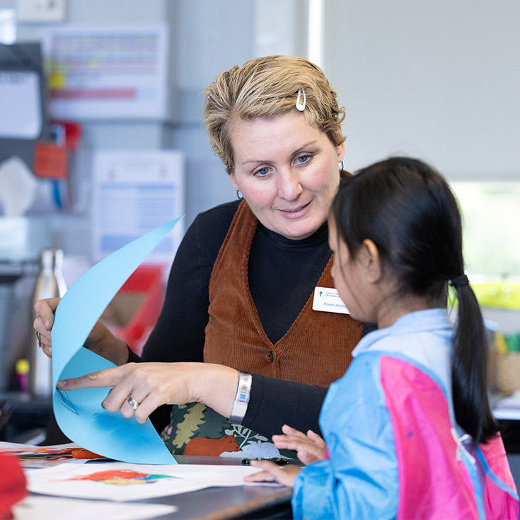 St Canice's Katoomba teacher assisting a student in art class.