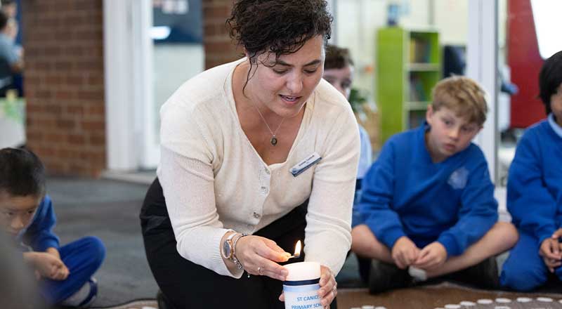 St Canice's Katoomba teacher lighting candle in Religion class