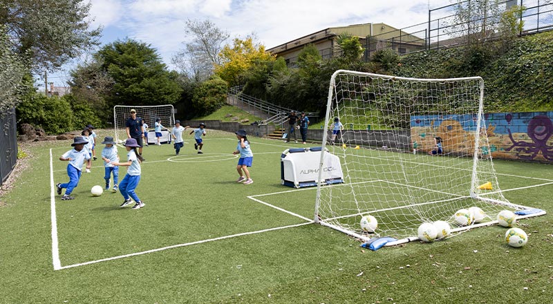 Students outdoors at St Canice's Katoomba playing soccer