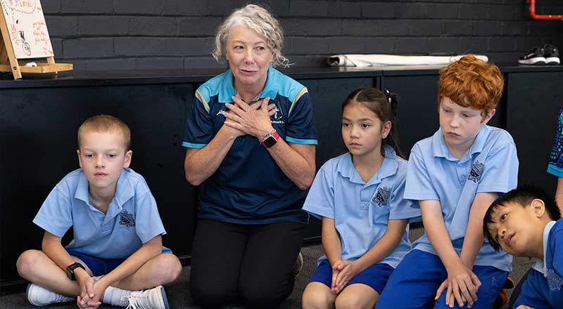 Student and teachers praying at St Canice's Katoomba