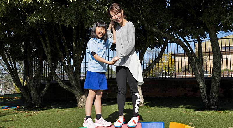 Parent and student at St Canice's Katoomba on play equipment